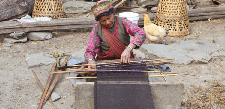 She is weaving their custom traditional in Ghatlang. 