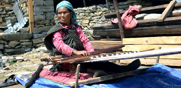 In Tipling, weaving their traditional costume.  