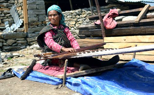 In Tipling, weaving their traditional costume.  